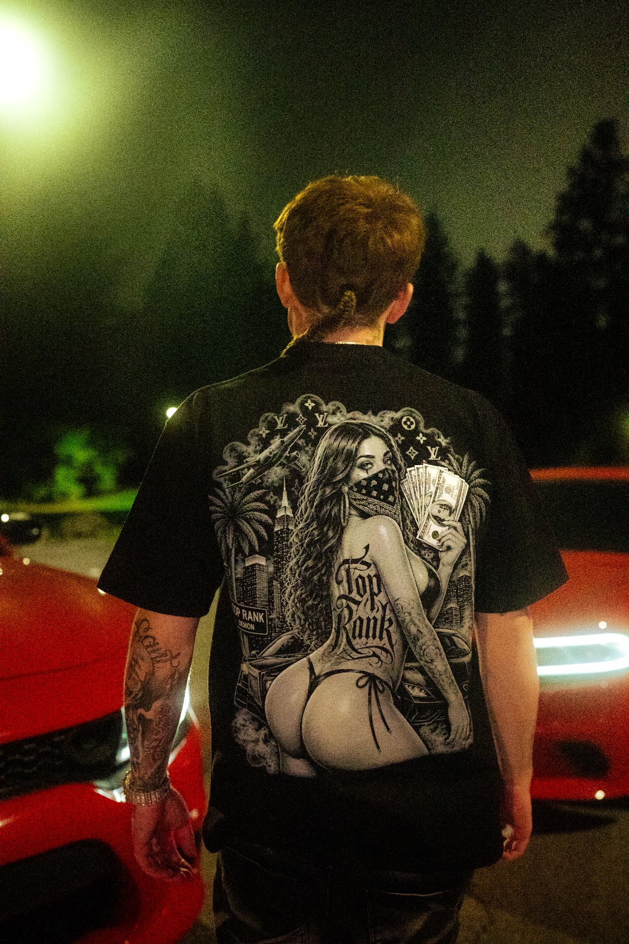 Product of the Struggle Tee back graphic worn at night