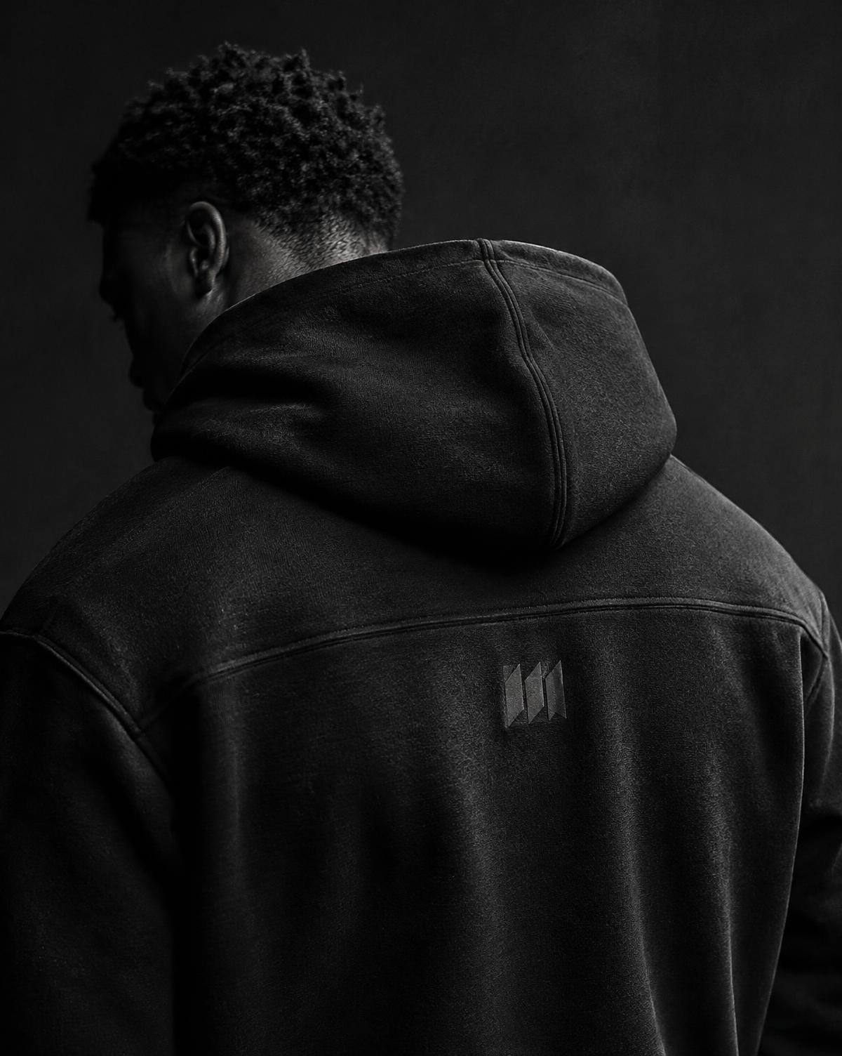 Close detail of TOP RANK black hooded garment